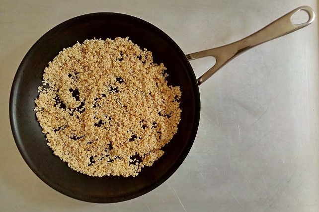 Toasting_sesame_seeds_in_a_small_frying_pan_to_increase_flavour