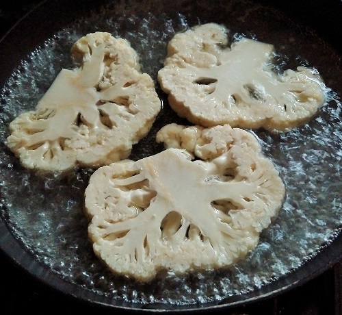 Poaching_cauliflower_steaksin_gently_simmering_water