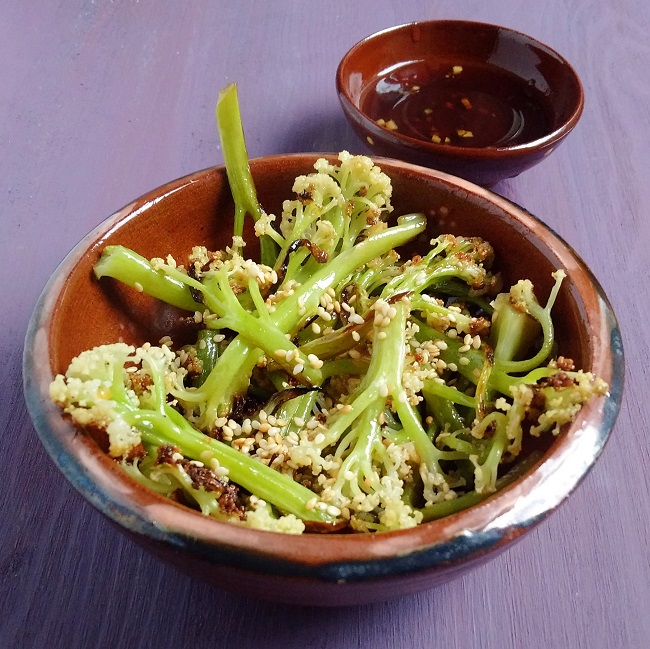 Bowl_of_freshly_cooked_cauliflower_stems_dressed_with_teryiaki_and_sesame_seeds