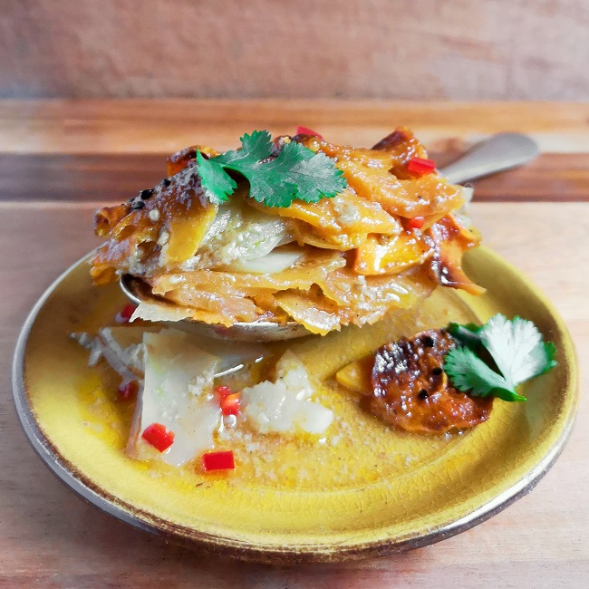 A_spoonful_of_sliced_of_swede, sweet potato_and_potato_cooked_in_coconut_milk_and_curry_powder