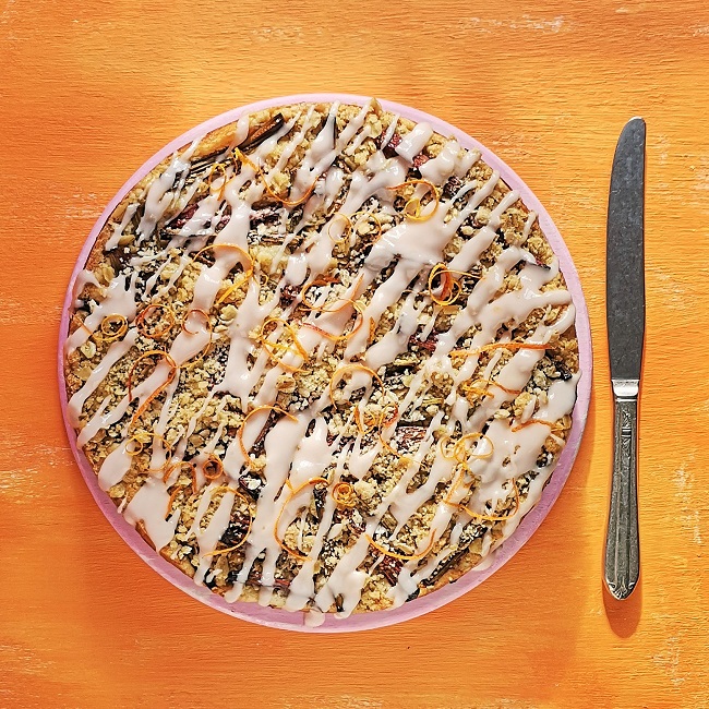 Overhead_image_of_iced_and_decorated_rhubarb_and_orange_streusel_cake