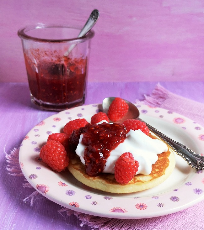 Small_pancake_with_coconut_yogurt_raspberries_and_a_generous_spoonful_of_reduced_sugar_raspberry_jam