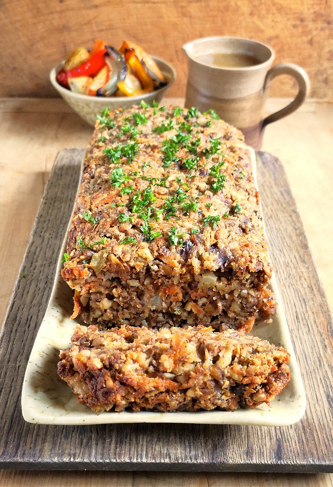 Whole_nutloaf_with_slice_on_board_with_roast_veg_and_gravy