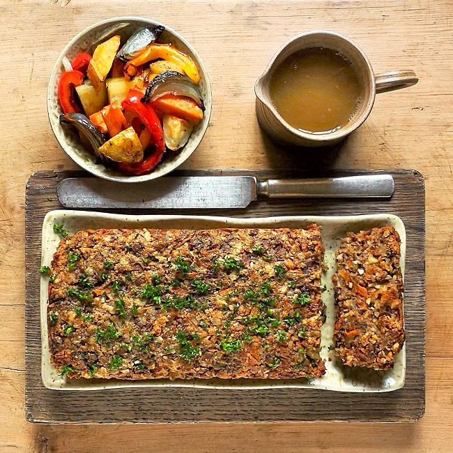 Overhead_image_of_homemade_nut_loaf_with_a_bow_of_roast_vegetables_and_vegetable_gravy