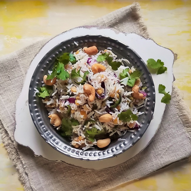Indian-style_rice_and_peas_mixed_and_served_in_a_metal_bowl